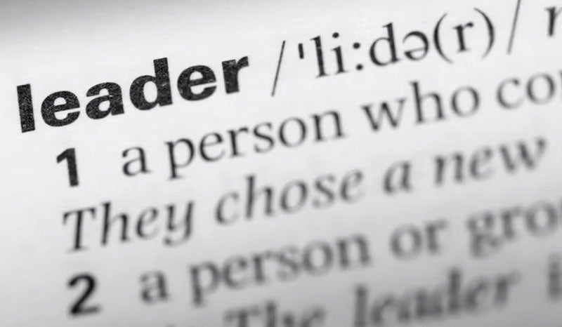 A close-up of a dictionary entry defining the word "leader."