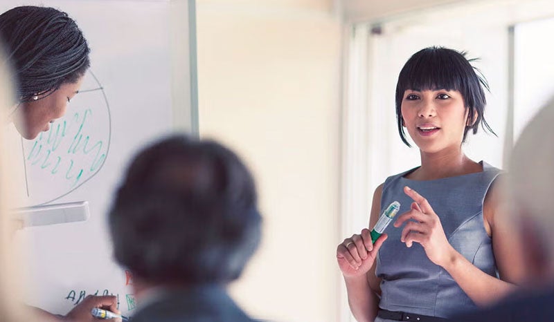 A diverse group of professionals brainstorming in an office.